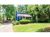 Charming blue two-story home with well-manicured lawn and mature trees at 737 Polk Nw St, Marietta, GA 30064
