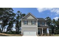 Charming two-story home with gray siding, a covered porch, and an attached two-car garage at 45 Heyman Dr, Covington, GA 30016