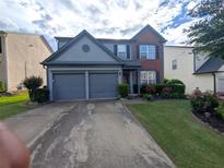 Charming two-story home with a well-manicured lawn and a two-car garage in a suburban neighborhood at 640 Dahoma Trl, Woodstock, GA 30188