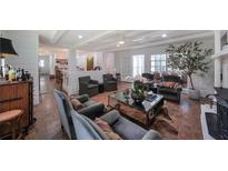 Cozy living room featuring a brick fireplace, hardwood floors, and comfortable seating arrangements with natural lighting at 167 Garden Ln, Decatur, GA 30030