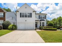 Charming two-story home with a well-maintained lawn and a two-car garage at 3710 Ridgefair Dr, Cumming, GA 30040