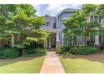 Charming townhome with mature landscaping, a walkway to the front door and serene curb appeal at 510 Independence Way, Roswell, GA 30075