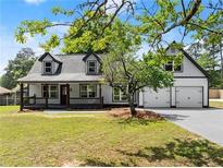 Charming two-story home with a welcoming front porch and attached two-car garage at 2979 Overwood Sw Ln, Snellville, GA 30078
