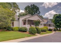 Charming home exterior with a covered front porch and well-maintained landscaping at 1453 Cambridge Cmn, Decatur, GA 30033