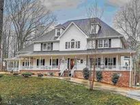 Inviting two-story home with a spacious wraparound porch and classic white siding at 125 Sir Lancelot Ct, Fayetteville, GA 30214