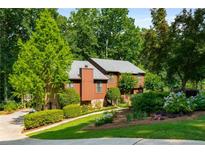 Charming two-story home with a beautiful landscaped yard and mature trees at 278 Shire Way, Lawrenceville, GA 30044