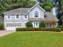 Charming two-story home with landscaped front yard and attached two-car garage at 750 Whitehall Way, Roswell, GA 30076