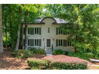 Charming two-story traditional home with well-manicured landscaping and shuttered windows at 799 Birds Se Ml, Marietta, GA 30067