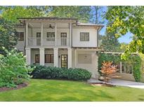 Charming two-story home featuring a well-manicured lawn and inviting front porch at 118 Chelsea Dr, Decatur, GA 30030