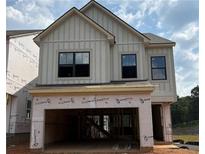 Charming two-story home with black framed windows and an attached two-car garage at 943 Crestmanor Dr, Marietta, GA 30008