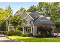 Beautiful two-story home with a stone facade, manicured lawn, and lush landscaping creates great curb appeal at 4789 Crest Park Ln, Marietta, GA 30068