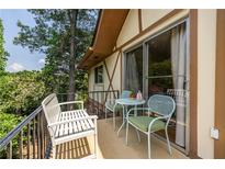 Relaxing balcony with seating provides a cozy outdoor living space with lush green tree views at 1225 Church St # M, Decatur, GA 30030