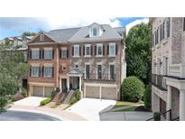 Elegant townhome with brick facade, attached garages, and well-maintained landscaping at 2283 Falmouth Se Ct # 22, Smyrna, GA 30080