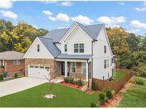 Beautiful two-story home featuring a stone and white shingle facade with well-manicured front yard at 474 Haley Se St, Marietta, GA 30060
