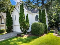 Charming white home with manicured lawn, two-car garage, and lush landscaping at 2348 Logan Ne Cir, Brookhaven, GA 30319
