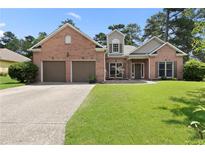 Charming brick home featuring a well-manicured lawn and an attached two-car garage at 3011 Stillwater Dr, Villa Rica, GA 30180
