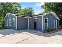 Charming home exterior with gray siding, white trim, and a well-maintained front yard at 356 Lake Dr, Atlanta, GA 30354