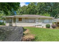 Charming single-story home with a quaint front porch and a well-maintained lawn at 2083 Meador Se Ave, Atlanta, GA 30315