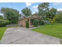 Charming single Gathering home with well manicured lawn and driveway at 219 1St St, Woodstock, GA 30188