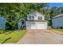 Charming two-story home featuring a two-car garage and a cozy front porch entrance at 7021 New Dale Rd, Rex, GA 30273