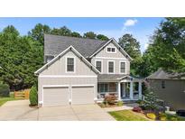 Charming two-story home featuring a gray exterior, a two-car garage, and a welcoming front porch at 428 Gold Xing, Canton, GA 30114