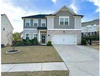 Charming two-story home with well-manicured lawn and a two-car garage, perfect for suburban living at 306 Coppergate Ct, Canton, GA 30115