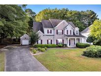 Beautiful two-story home with landscaped yard and a detached two car garage at 5735 Lake Windsor Pkwy, Buford, GA 30518