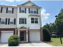 Charming townhome with a two-car garage, brick accents, and lush landscaping at 6798 Blackstone Pl # 12, Mableton, GA 30126