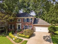 Charming brick home with mature trees and a well-manicured lawn at 4105 Vicksburg Dr, Lawrenceville, GA 30044