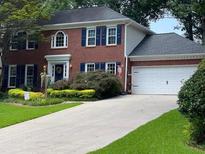 Charming two-story brick home with well-manicured lawn and two-car garage at 4105 Vicksburg Dr, Lawrenceville, GA 30044