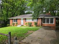 Charming brick home with manicured lawn, black shutters, and a cozy, inviting appeal at 510 Se Boyds Se Dr, Marietta, GA 30067