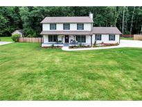 Charming two-story home with a well-manicured lawn and a welcoming front porch at 175 Hunters Gln, Fayetteville, GA 30215