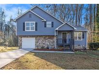 Charming two-story home featuring a stone facade and blue siding at 100 Spicewood Ct, South Fulton, GA 30349