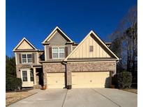Charming two-story brick home with a two-car garage and well-manicured landscaping at 455 Lakeside Vw, Fairburn, GA 30213