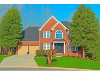 Charming two-story home with manicured lawn, mature trees, and a two-car garage at 505 Armor Knl, Powder Springs, GA 30127