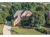 Beautiful brick two-story home with a landscaped yard and long driveway at 5347 Harbury Cv, Suwanee, GA 30024