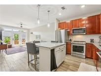 Bright kitchen features stainless steel appliances, granite counters, and an island with bar seating at 840 United Se Ave # 205, Atlanta, GA 30312