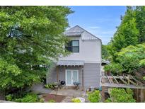 Two-story home showcasing an inviting outdoor patio area and lush surrounding greenery at 183 Cleveland # B, Atlanta, GA 30316