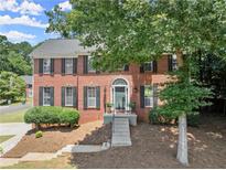 Charming two-story brick home with landscaped yard and welcoming front entrance at 1520 Dorchester Dr, Lawrenceville, GA 30043