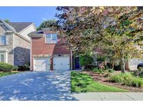 Charming two-story brick home with a well-maintained front yard and a two-car garage, perfect for Gathering living at 1668 Legrand Cir, Lawrenceville, GA 30043