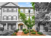 Charming townhome with landscaped front yard and brick-paved walkway to the front door at 3641 Princeton Ave, Atlanta, GA 30337