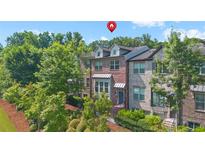 Beautiful brick townhome with well-maintained landscaping and mature trees in a desirable community at 5504 Cameron Parc Dr, Alpharetta, GA 30022