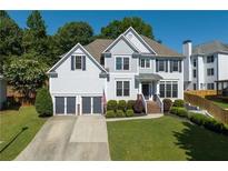 Charming two-story home with a well-maintained lawn and two-car garage in a residential neighborhood at 998 Poplar Mill Ct, Buford, GA 30518
