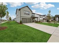 Charming two-story home with a well-manicured lawn and a two-car garage at 1001 Starmoss Ln, Conyers, GA 30094