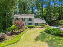 Charming two-story home with well-manicured landscaping and a lush green lawn at 4686 Buckskin Sw Trl, Lilburn, GA 30047
