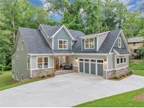 Inviting two-story home featuring a spacious driveway and a blend of modern architectural design with lush green surroundings at 331 Terrell Sw Dr, Marietta, GA 30064