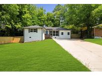 Charming single-story home featuring a well-maintained lawn and a long driveway at 3388 Elgin Dr, Decatur, GA 30032