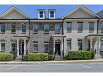 Charming brick townhomes with well-maintained landscaping and inviting front entrances at 3879 Glenview Club Ln, Duluth, GA 30097