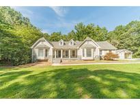 Charming single-story home featuring a symmetrical facade, bay windows, and a well-manicured lawn at 4120 Grady Smith Rd, Loganville, GA 30052