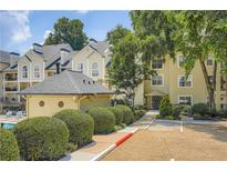 Inviting condominium complex featuring well-manicured landscaping and a community pool, perfect for relaxation at 3655 Habersham Ne Rd # 344, Atlanta, GA 30305